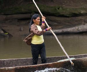Indigene Frau auf einem Einboot im ecuadorianischen Amazonasgebiet.
