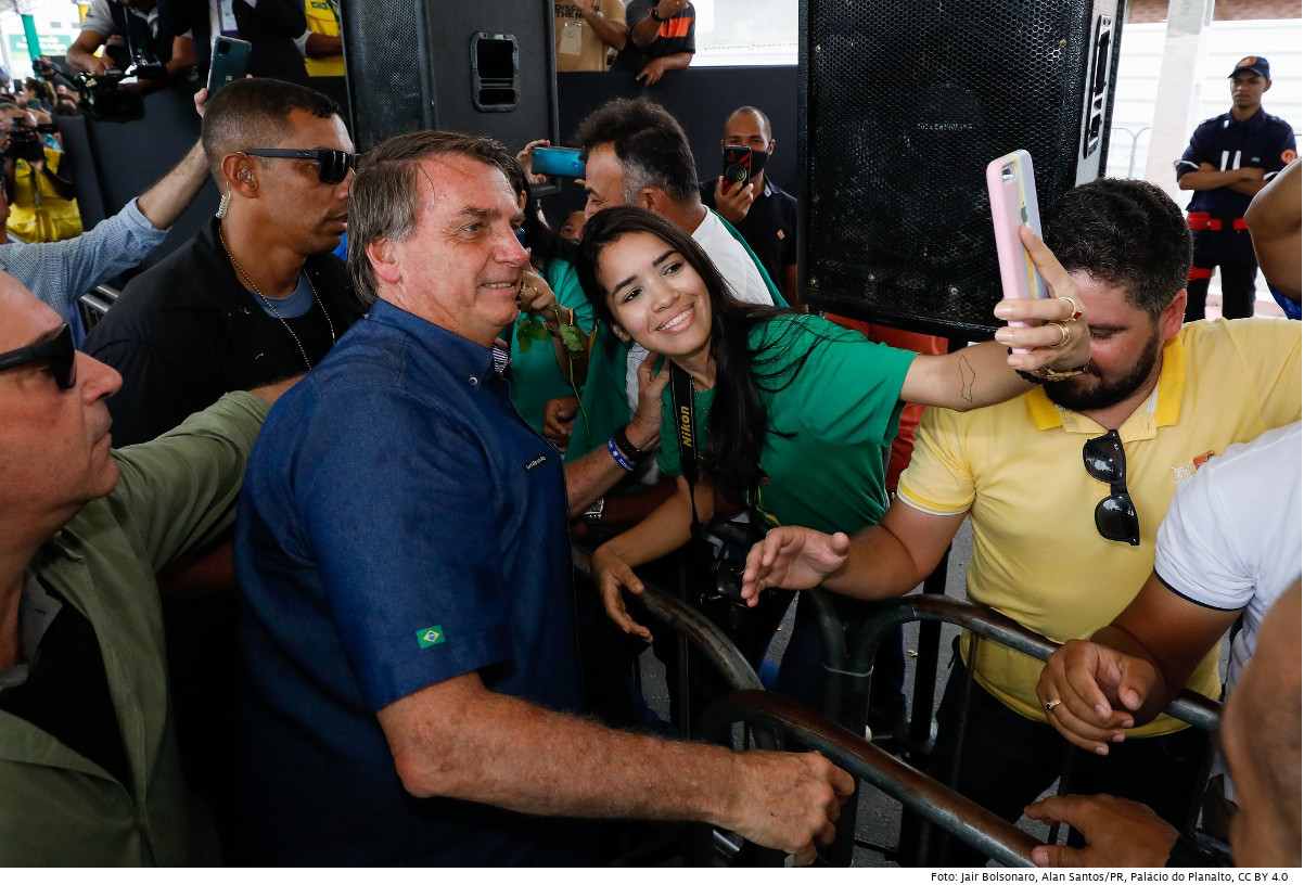 Brasiliens Präsident Jair Bolsonaro gibt sich gern volksnah. Hier lässt er sich mit einer Bürgerin von Alameda do Farol auf einem Selfie ablichten. Foto: Jair Bolsonaro cumprimenta cidadãos, Alan Santos/PR, Palácio do Planalto, CC BY 4.0